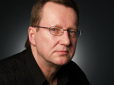 man in black shirt wearing eyeglasses with silver frames thumbnail