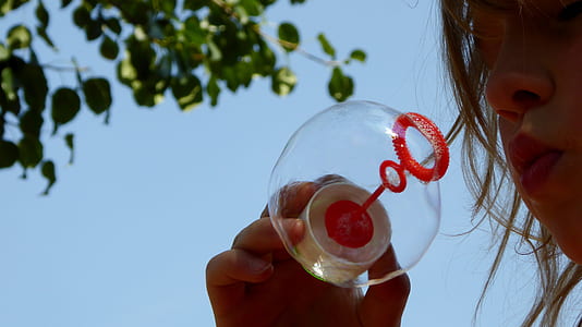 girl playing with bubble near tree thumbnail