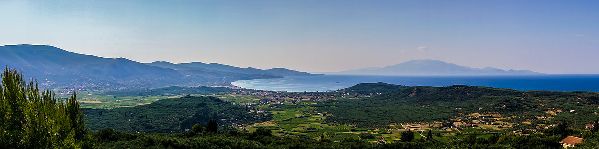 mountain near body of water under blue sky thumbnail