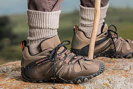 Men's Brown and Gray Merrell Hiking Shoes Holding Stick thumbnail