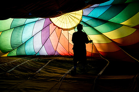 person standing of yellow and brown parachute thumbnail