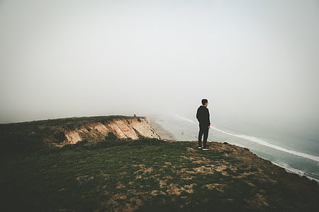 man standing near body of water thumbnail