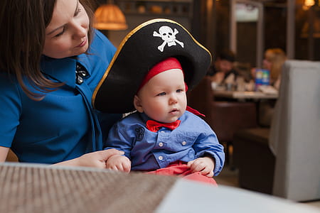 woman cuddling baby in pirate costume thumbnail