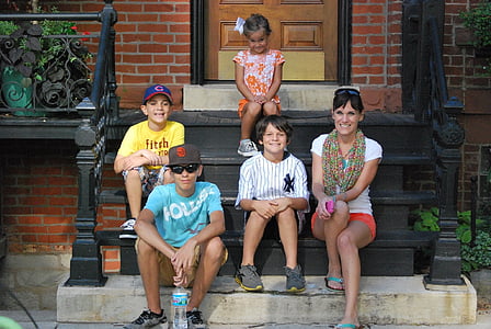 family sitting on black stair smilling during daytime thumbnail