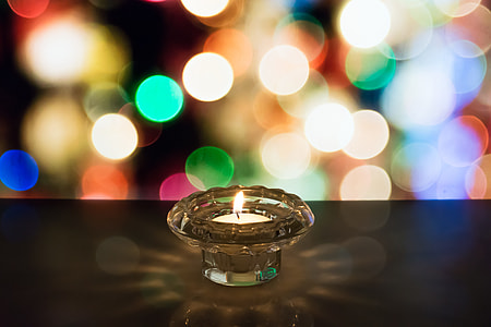 bokeh photography of lit votive candle thumbnail