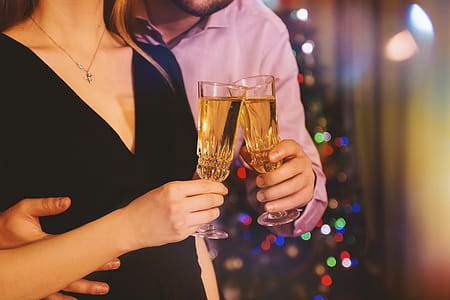Man hugging his woman while they celebrate with champagne in hands at home thumbnail