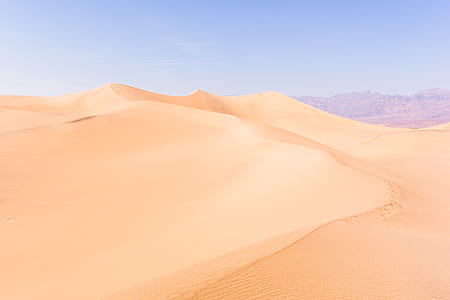 aerial photography of desert under clear blue sky during daytime thumbnail