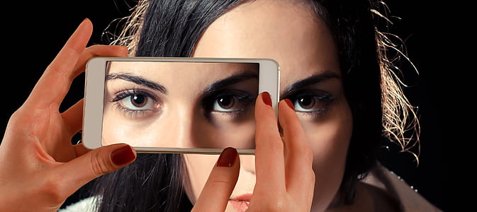 woman taking picture of her eyes thumbnail