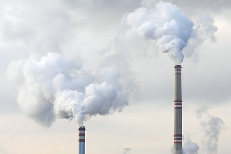 Factory chimney blowing some smoke in the air thumbnail