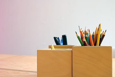 assorted-color coloring pencils in square brown wooden pencil holder thumbnail