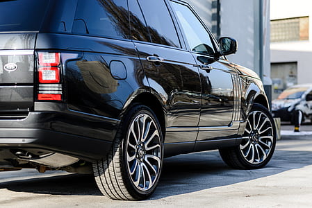 black Land Rover Range Rover SUV on concrete road thumbnail