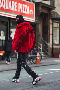 man walking on asphalt road during daytime thumbnail