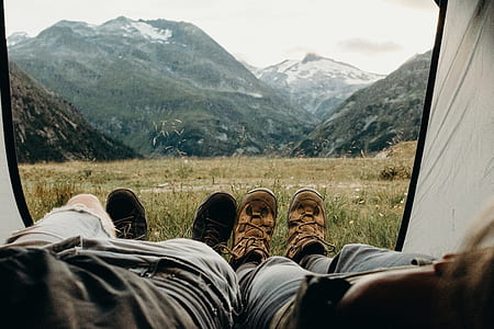 two person lying inside tent facing mountain thumbnail