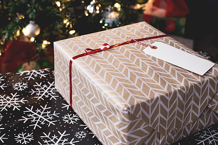 beige and white gift box on brown and white snowflake print textile thumbnail