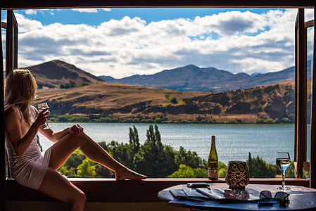 woman sitting on porch looking at mountains during daytime thumbnail