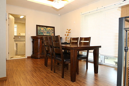 brown wooden dining table near glass wall thumbnail