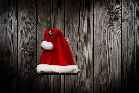 red santa hat on top of gray wood thumbnail