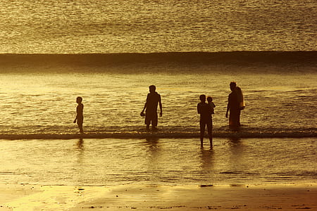 people standing in seashore in sepia photography thumbnail