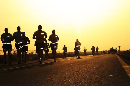 people running on road during daytime thumbnail