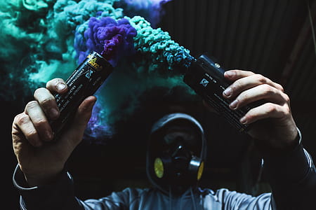 person holding two smoke flares thumbnail