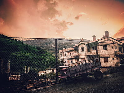 Black Utility Trailer Near White Concrete Building thumbnail