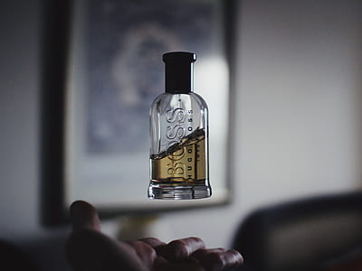 BOSS HUGO BOSS fragrance bottle floating on top of person's hand thumbnail