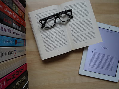 black framed eyeglasses on opened book thumbnail