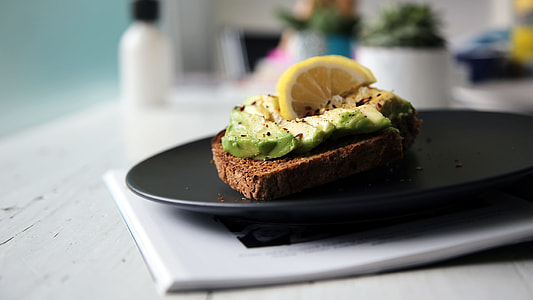 slice of lemon on black plate thumbnail