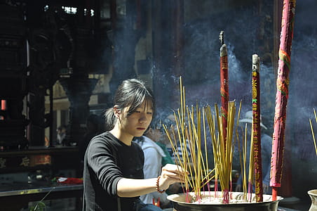 Woman Lighting Incense Sticks thumbnail