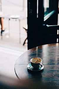 white teacup with saucer on wooden table thumbnail