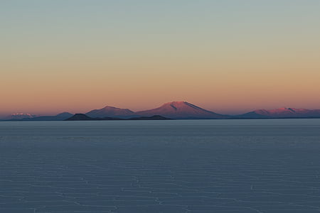 selective focus photography of water and mountain thumbnail