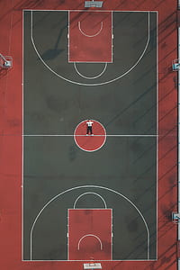 man lying in the middle of basketball court thumbnail