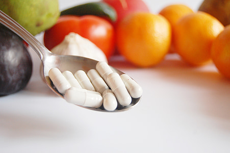 white capsules on spoon thumbnail
