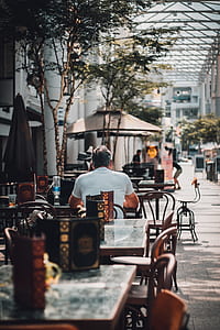 photo of man sitting beside table thumbnail