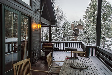 outdoor sconce by porch during winter season thumbnail