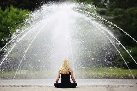 woman doing yoga in front of outdoor fountain thumbnail