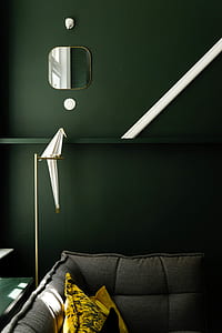 yellow pillow on gray sofa near on green painted wall thumbnail