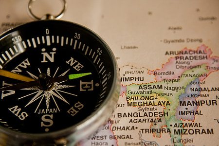 round silver-colored compass on map thumbnail