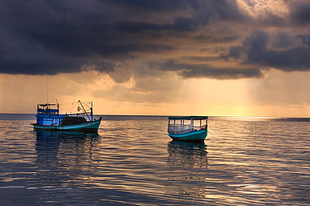 two sailing boats on body of water thumbnail