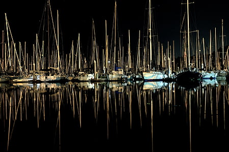 reflection photography of aligned sail boats thumbnail