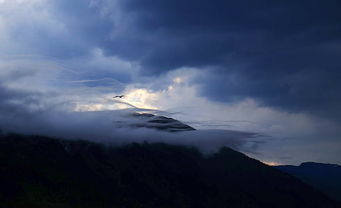 silhouette of mountain under gray sky thumbnail