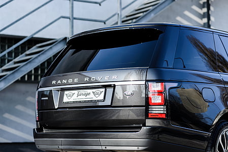 black Land Rover Range Rover SUV parked near gray metal stair case thumbnail