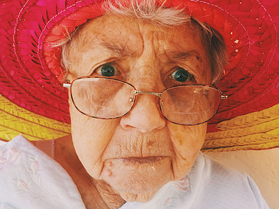 woman wearing red and yellow woven hat thumbnail