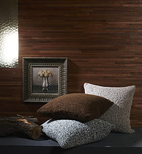 three throw pillows near framed flower in vase thumbnail