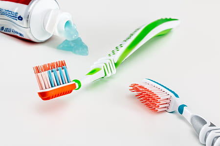 two green and gray toothbrushes on white surface thumbnail