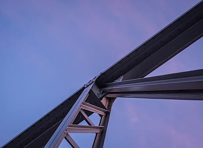 low-angle photo of gray full-suspension bridge under blue sky at daytime thumbnail
