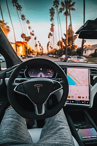 person in shorts inside of Tesla vehicle thumbnail