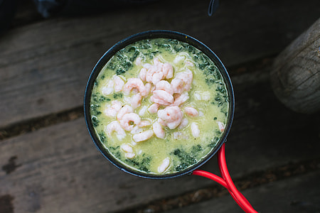 Cooking shrimps with spinach outside camping thumbnail