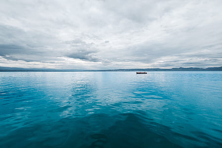 boat in the middle of body of water thumbnail