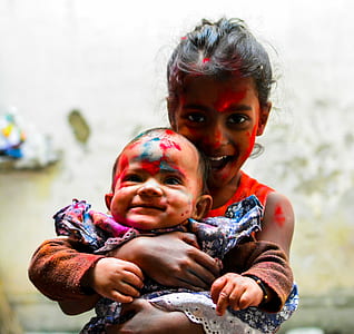 girl holding baby thumbnail